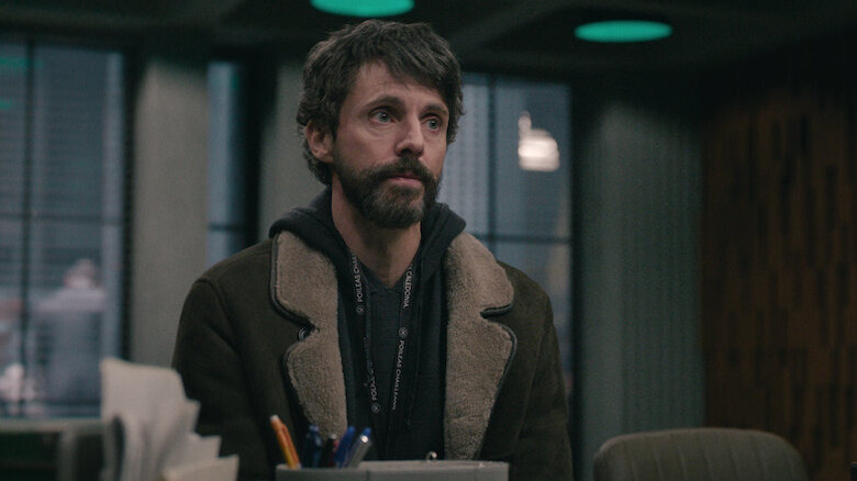 Morck sits uncomfortably at a desk in "Dept Q" (2025)