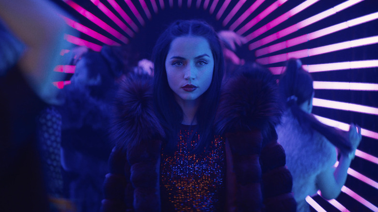 Eve Macarro strolling towards a target in "Ballerina" (2025)