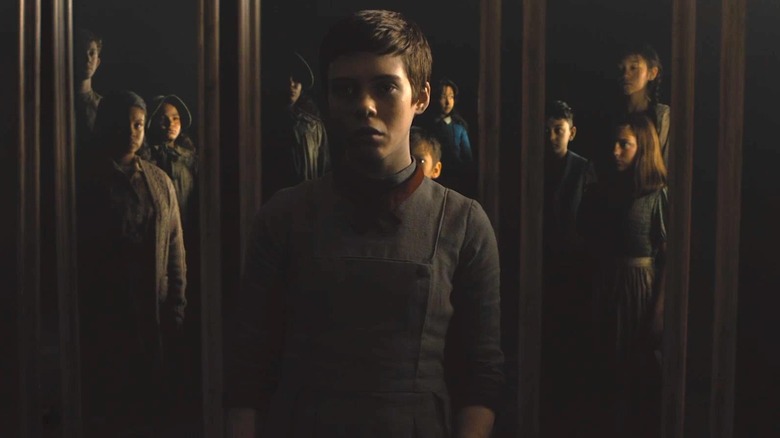Gretel standing in front of mirrored children in "Gretel & Hansel" (2020)