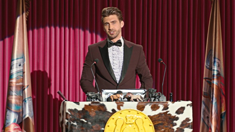 Chris Taylor as Host Ken in Barbie (2023)