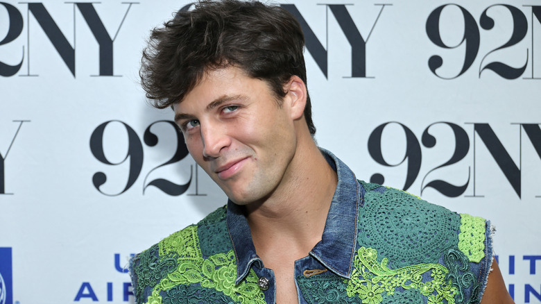 Rob Rausch grinning at a press event for "Love Island"