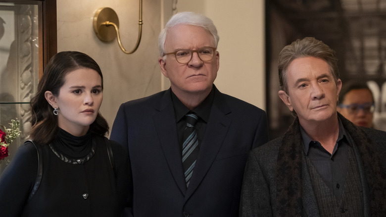 Mabel, Charles, and Oliver frowning at Lester's funeral (2025)