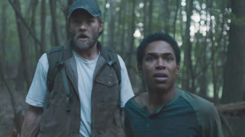 Paul and Travis spot something in the woods in "It Comes at Night" (2017)