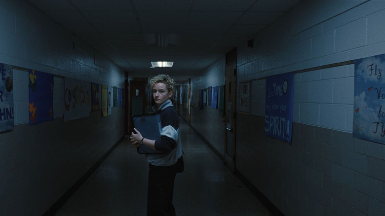 Justine Gandy looking around nervously in "Weapons" (2025)