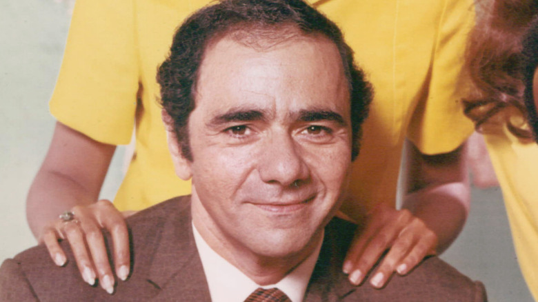 Michael Constantine smiles with Denise Nicholas's hands on his shoulders