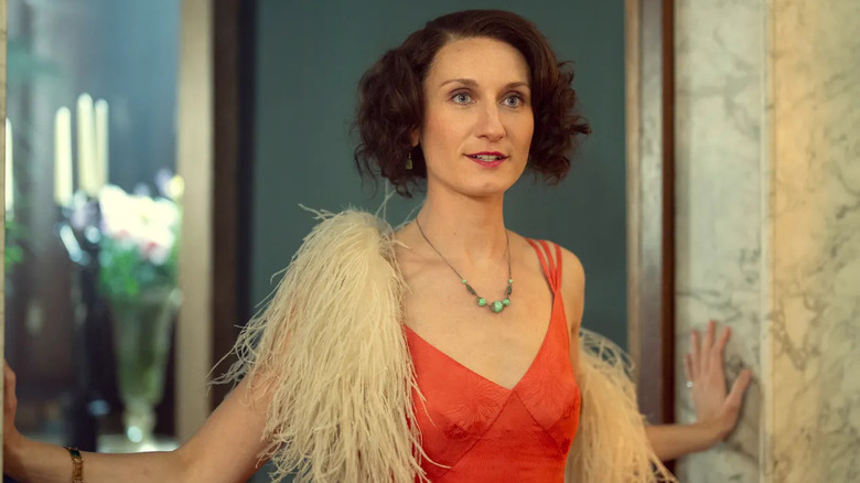 Nancy Mitford pauses in a doorway in "Outrageous" (2025)