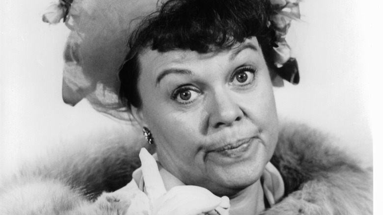 Mrs. Fowler purses her lips while wearing a fur stole and hat