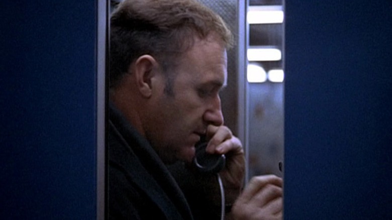 Jimmy "Popeye" Doyle holding a phone in a subway booth in "The French Connection" (1971)