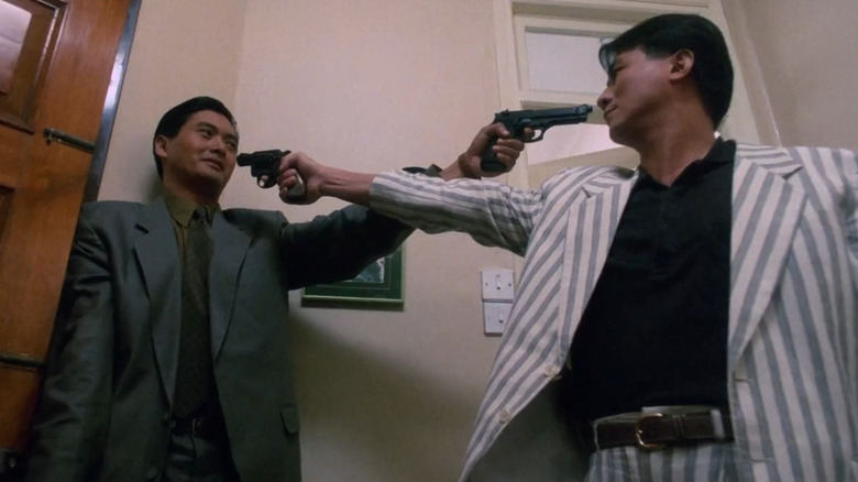 Ah Jong and Li point guns at each other in The Killer (1989)
