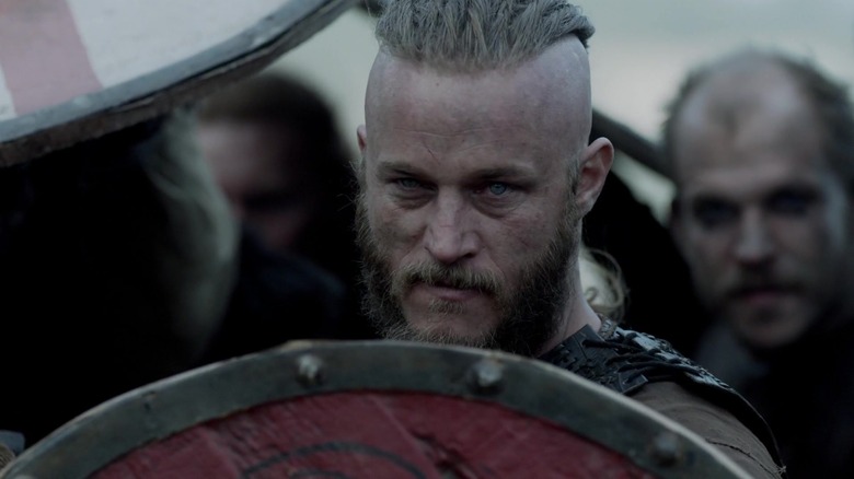 Ragnar stands behind a shield on Vikings