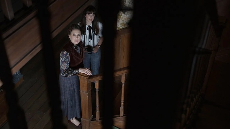 Lorraine Warren looking up a staircase nervously in "The Conjuring: Last Rites" (2025)